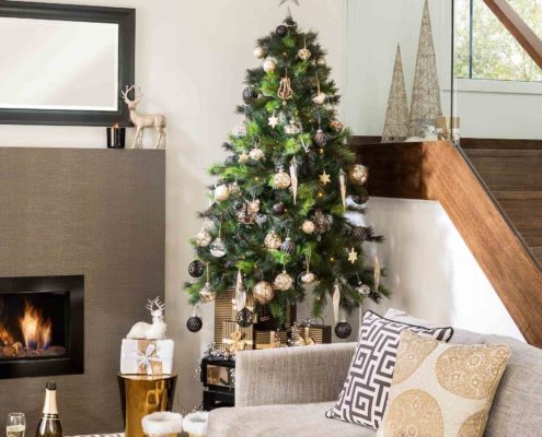 Modern home interior living room and open staircase with a Christmas tree.