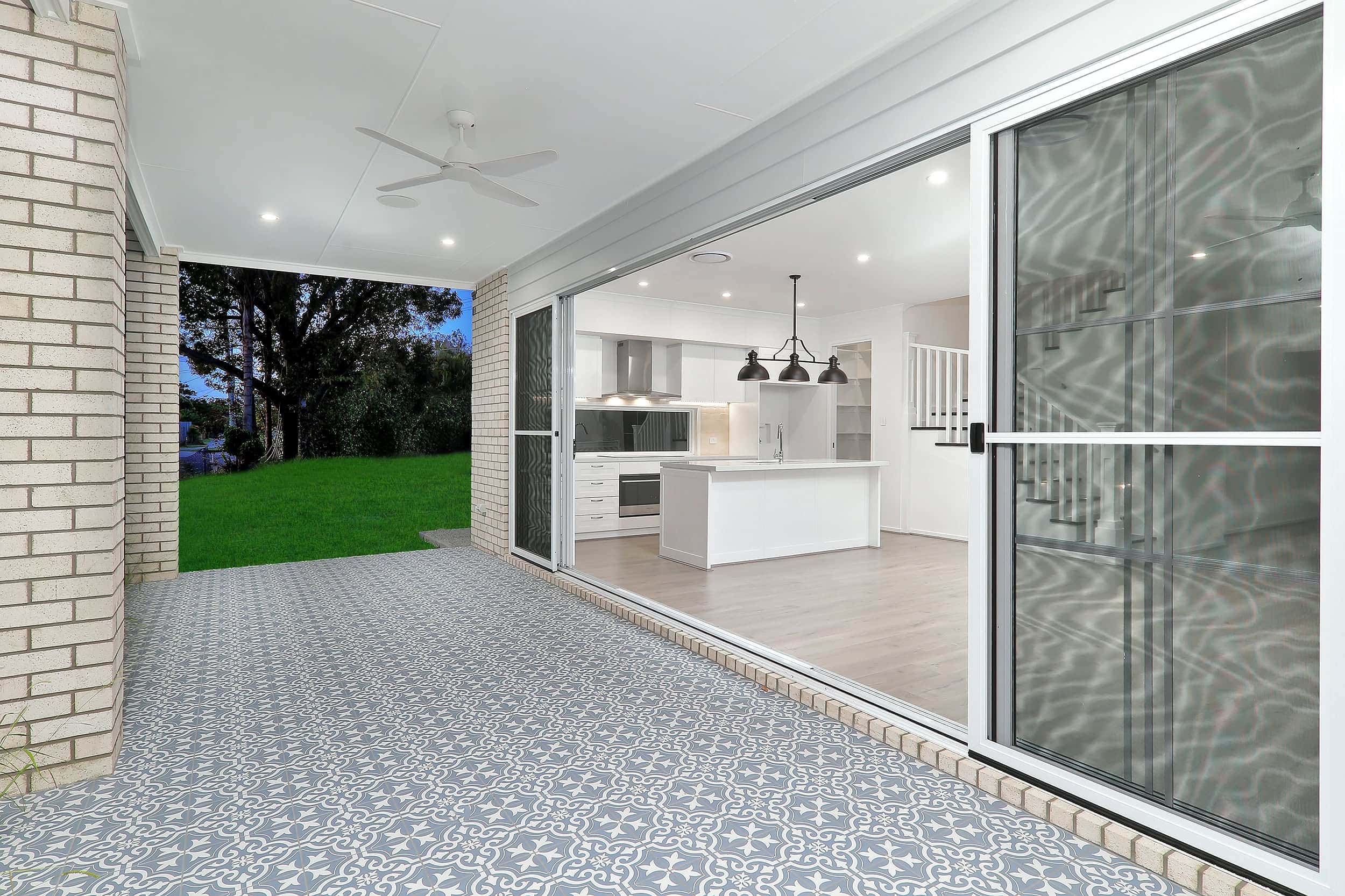 modern outdoor entertainment area with patterned tiles that lead into the kirchen