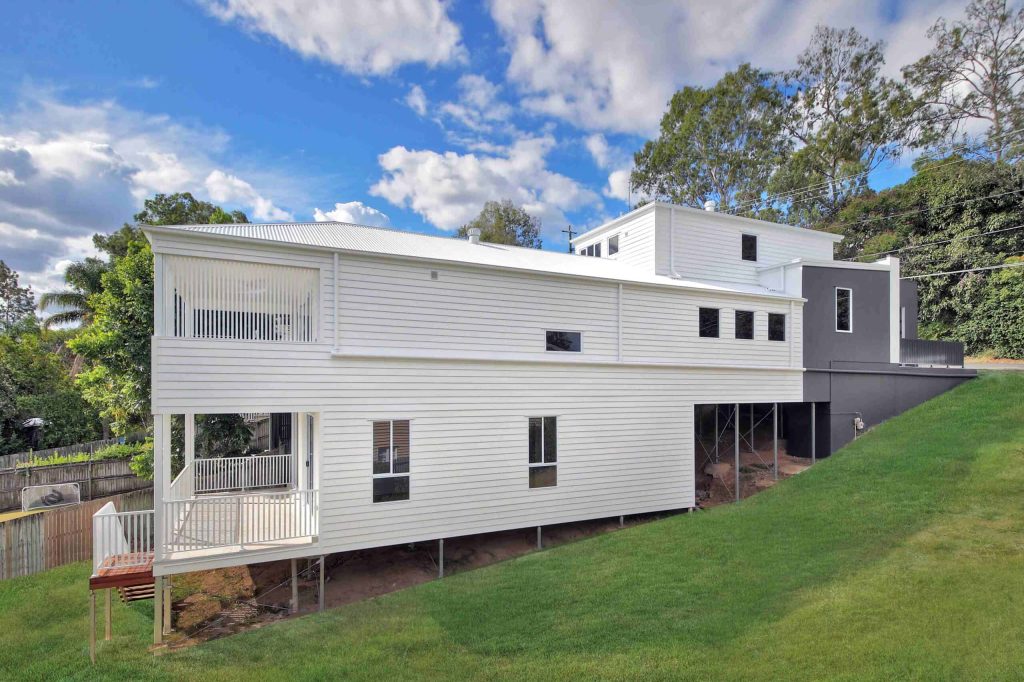 Weatherboard home on a sloping block with rear balcony in Alderley