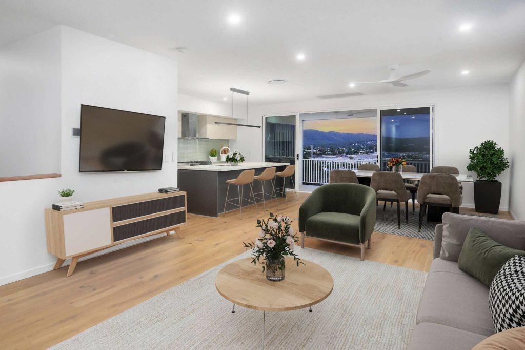 Open plan living, dining and kitchen with hillside views in an Alderley custom home