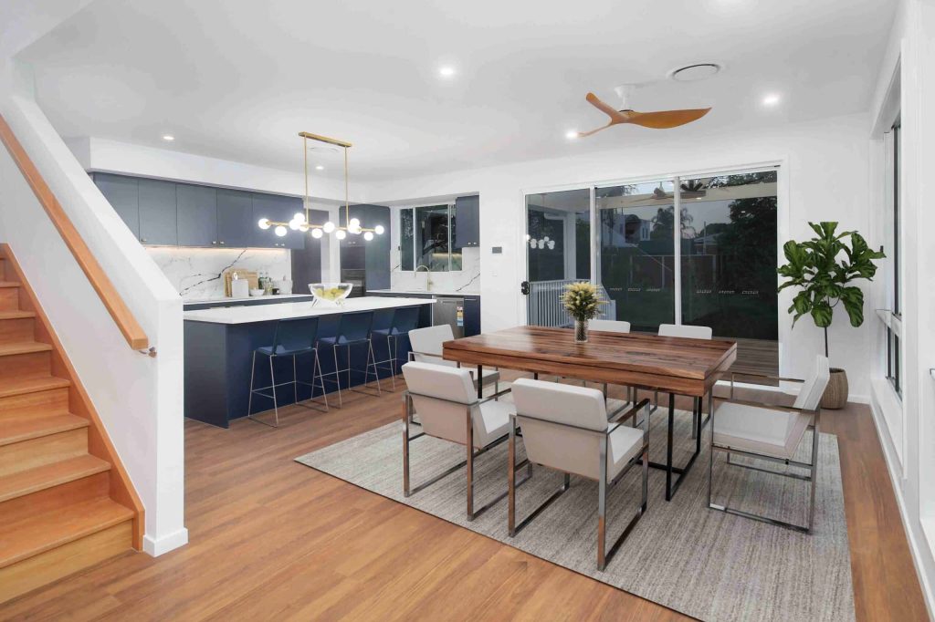 Dining area and kitchen with navy cabinetry and island bench in a Sunnybank custom home