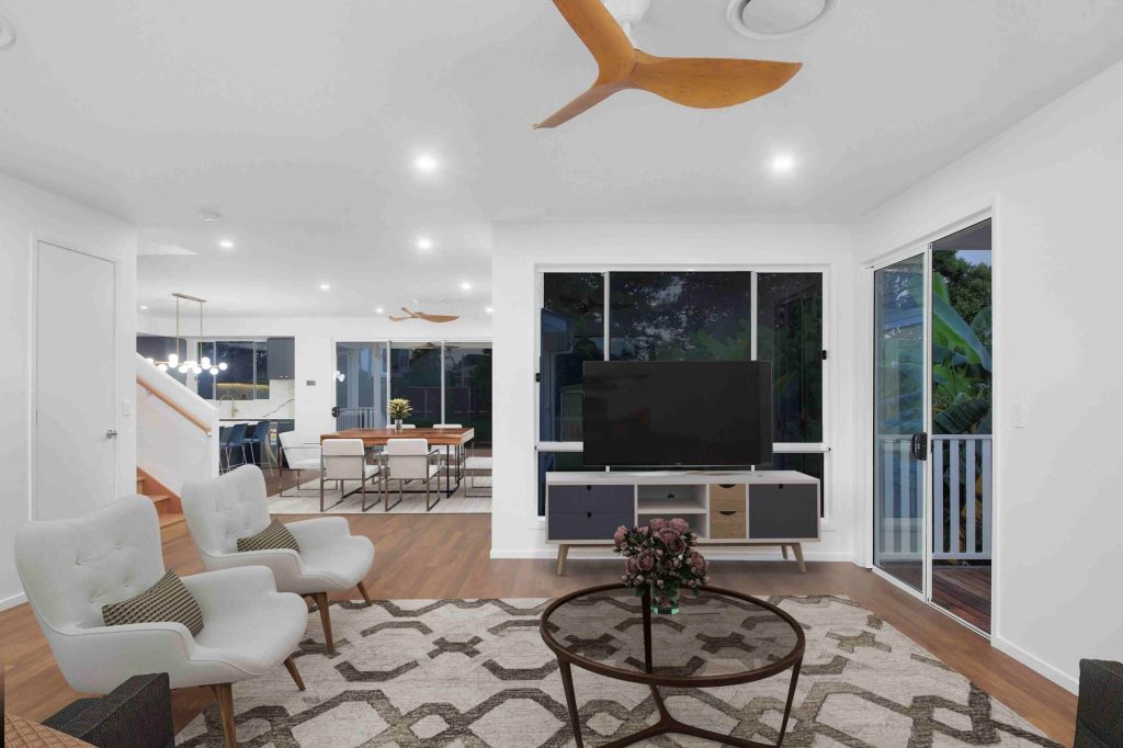 Open plan living and dining area with timber flooring in a Sunnybank custom home