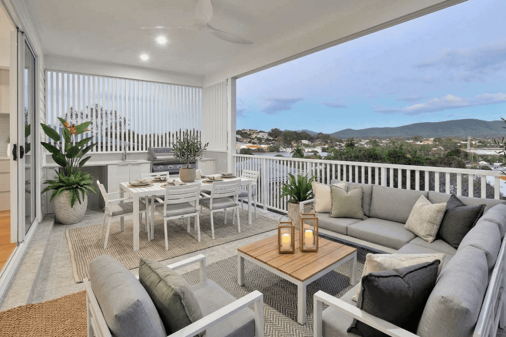 Covered rear balcony with outdoor lounge, dining and alfresco kitchen in an Alderley custom home